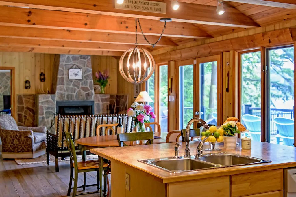 Rosseau Reflect -Muskoka- Kitchen counter, dining room, sitting room and first fireplace