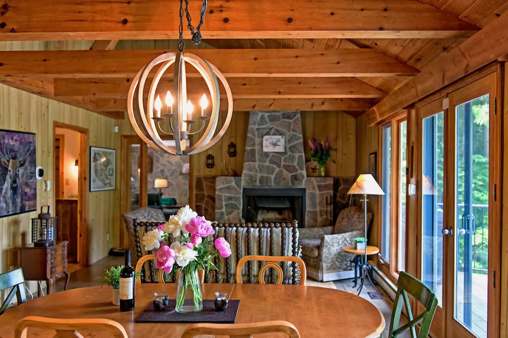 Rosseau Reflections - Muskoka Cottage - Dining room, sitting room and first fireplace